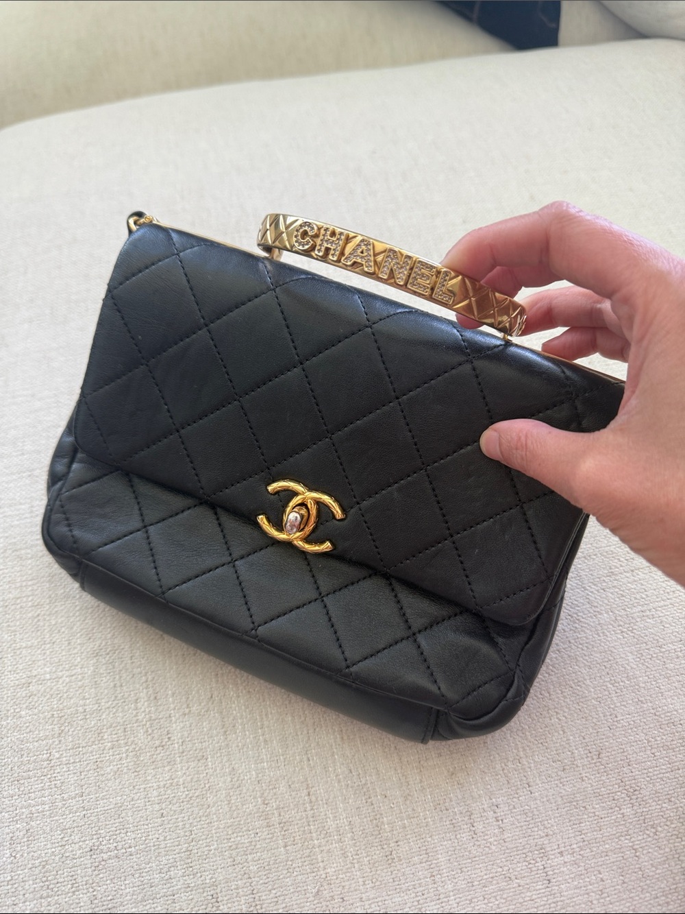CHANEL Black Quilted Shoulder Bag with Gold CC and Logo Bangle